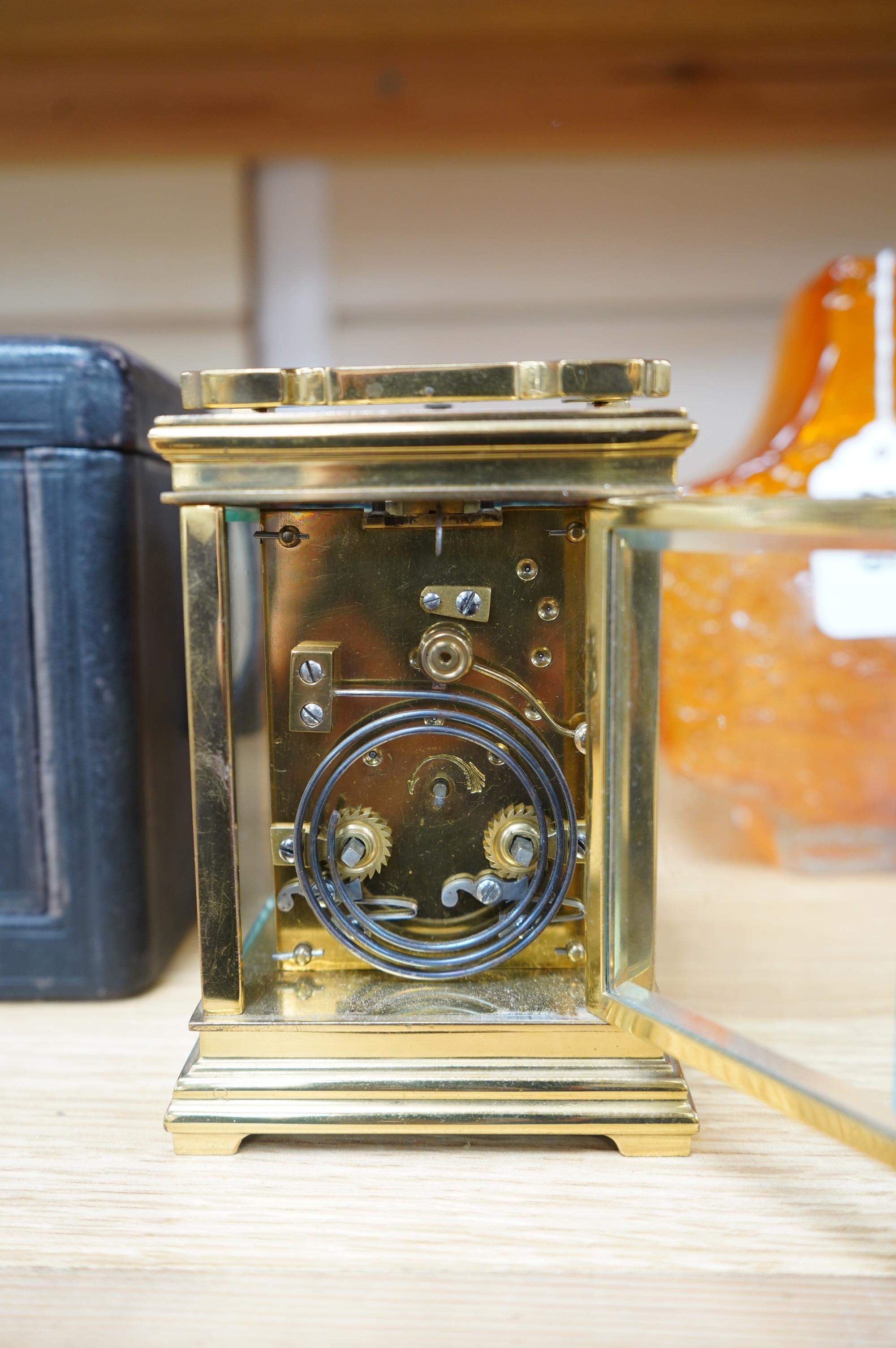 A late 19th century French brass cased eight day repeating carriage clock, Wilson & Sharp, in leather case. Condition - fair, not tested